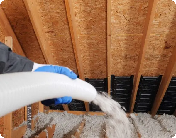 Loose-fill insulation being blown into an attic